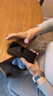 Céline, 93, using AidFone on her smartphone